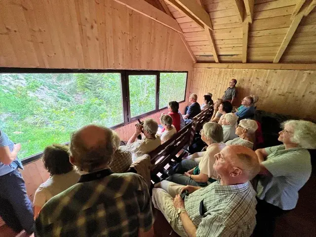 Wildlife enthusiasts seated inside a Romsilva-licensed bear watching hide in the Carpathian Mountains Romania